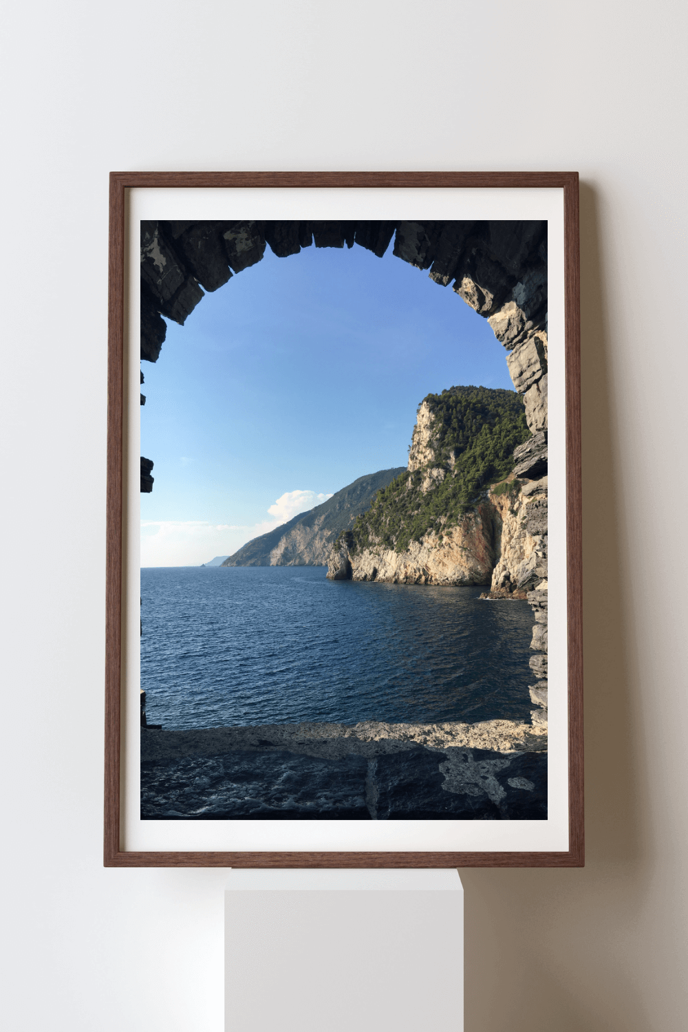 Beyond Dreams fine art travel photography print featuring a view of the ocean and mountains through a stone-carved window in Cinque Terre, Italy