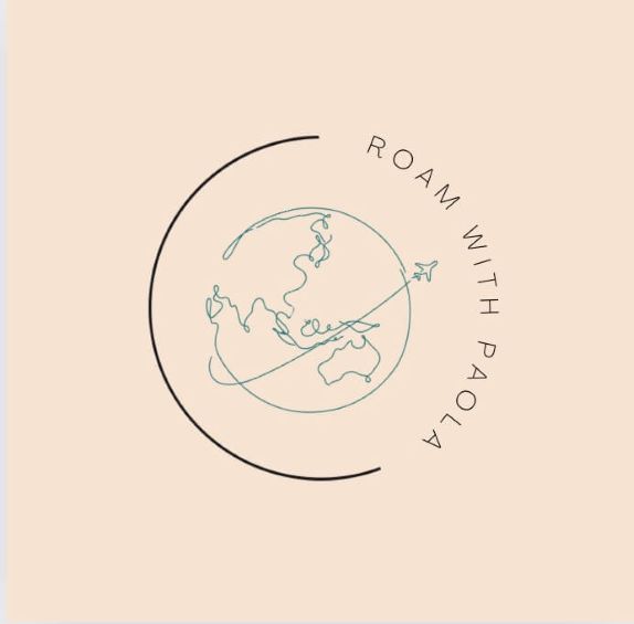 A minimalist logo on a soft peach background, featuring a thin teal line drawing of the Earth with a curved black ring and the text 'ROAM WITH PAOLA' in dark gray.