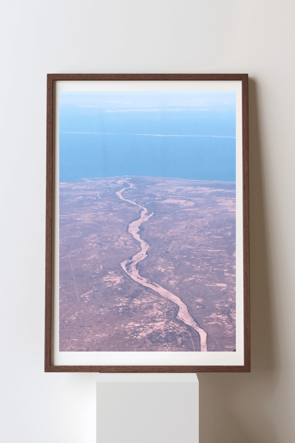 Crimson Earth fine art travel photography print featuring an aerial view of the crimson colour of the barren land in Australia