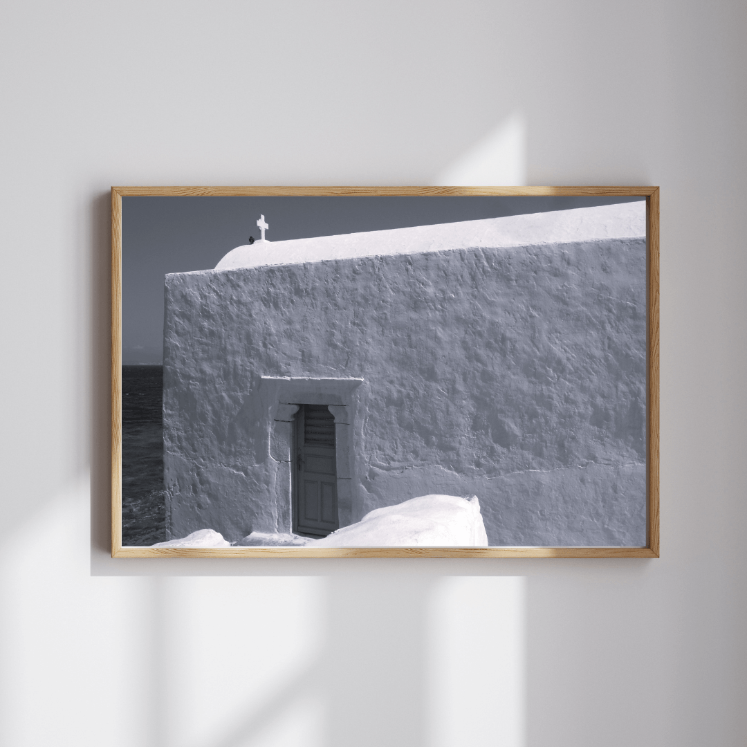 Grace on Stone fine art travel photography black and white print featuring a small cross on top of a whitewashed building in Mykonos, Greece