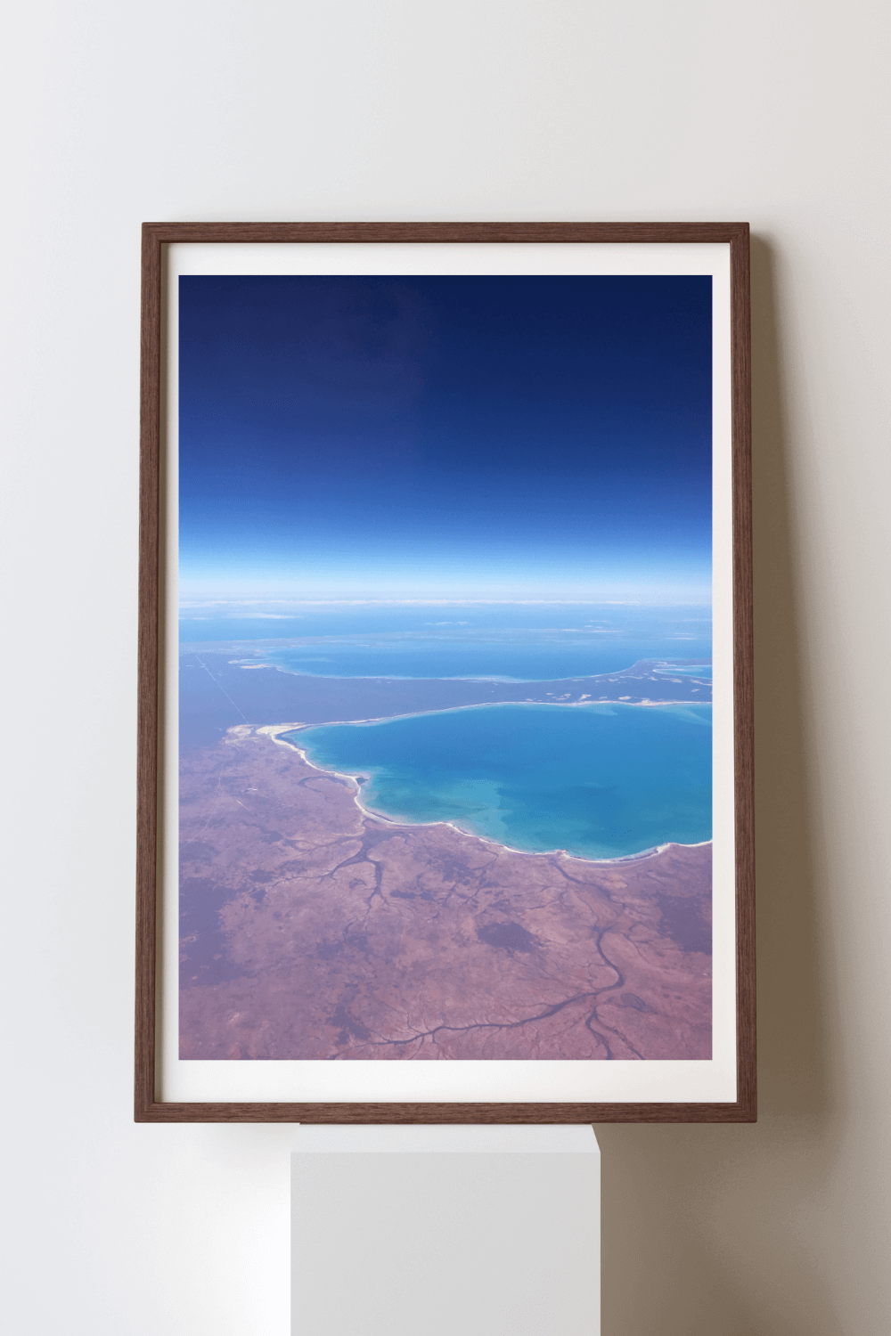 Horizon of Fire & Water fine art travel photography print featuring an aerial view of the deeply contrasting deep blue ocean against the red earth along the Western Australian coastline 