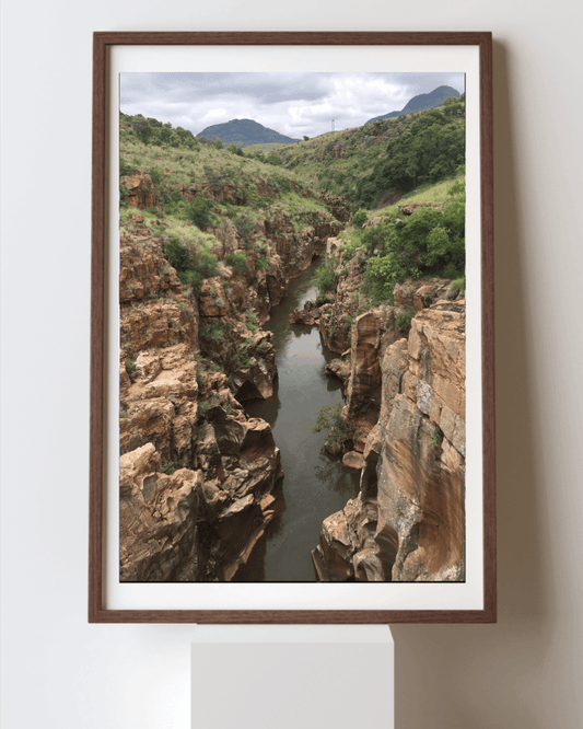 Nature's Passage fine art travel photography print featuring valley lined by lush green trees in South Africa 