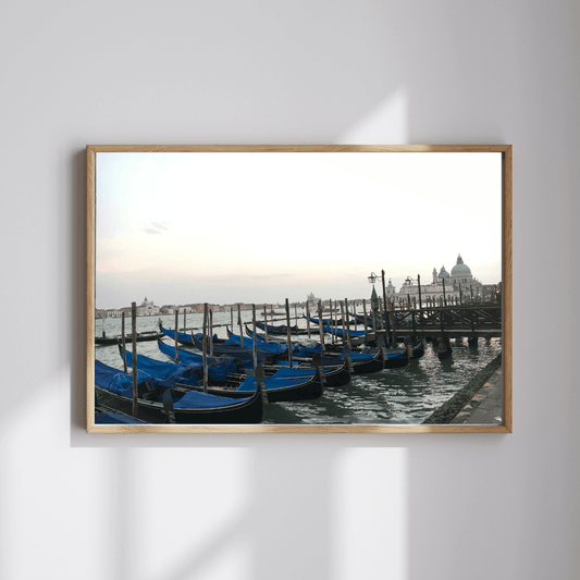Serene gondolas fine art travel photography print featuring blue gondolas moored in Venice, Italy