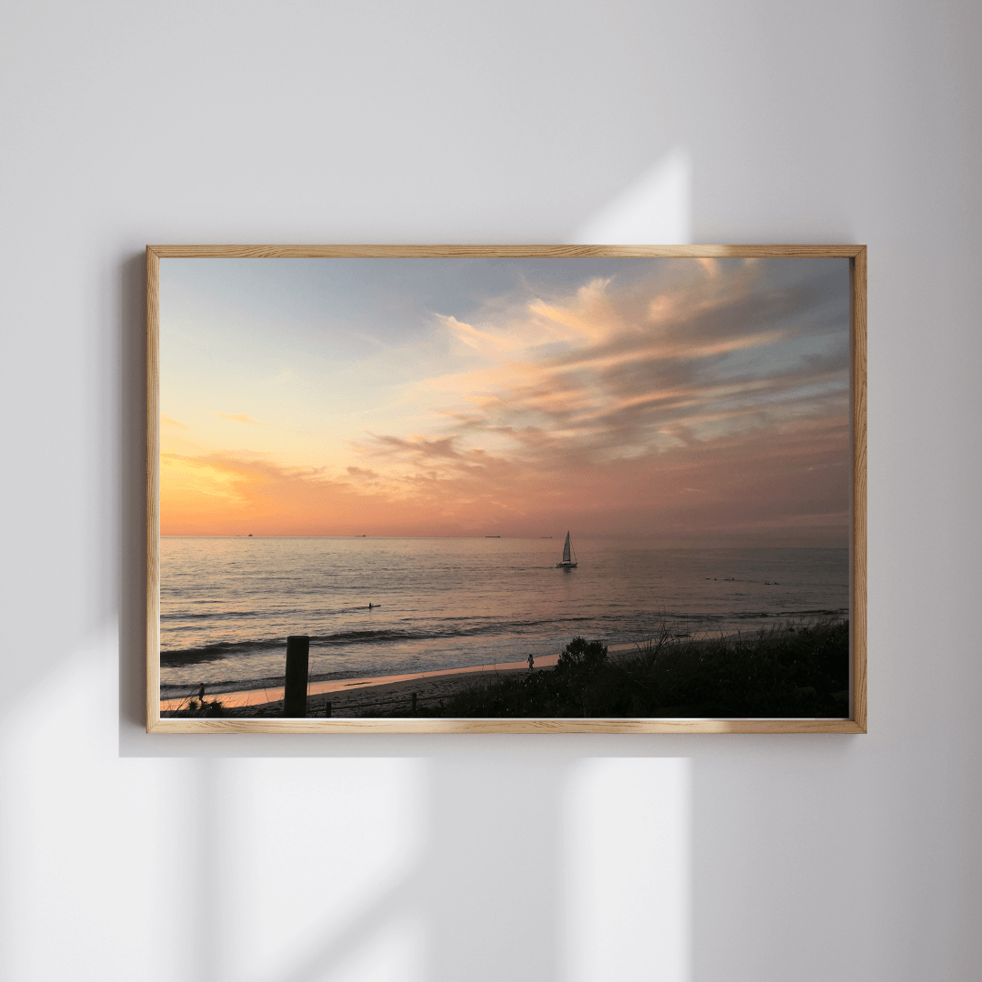 Sunset Solitude fine art travel photography print featuring a solitary sailboat on the beach at sunset in Cottesloe, Western Australia