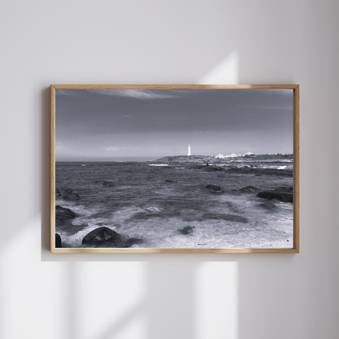 The Last Watcher fine art travel photography black and white print featuring a lighthouse in the distance with the ocean and shore at the forefront in Sydney, Australia