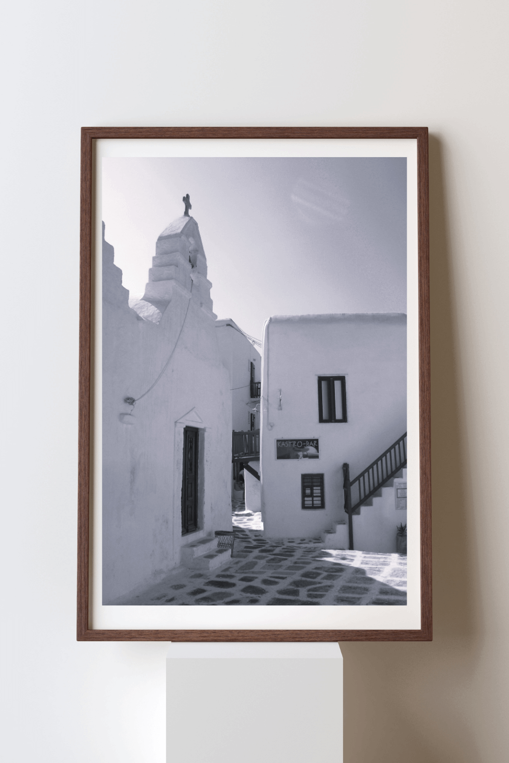 Whispers of the Aegean fine art travel photography black and white print featuring a small courtyard in Mykonos surrounded by iconic whitewashed homes and shops